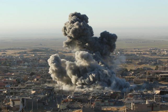 Smoke rises from the site of U.S.-led air strikes in the town of Sinjar