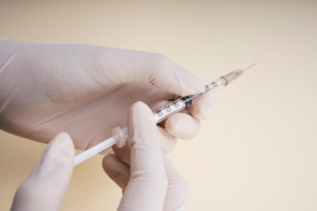 Doctor plastic gloves hand using syringe isolate over white back