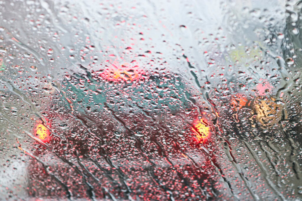 View from the car windscreen during rain and wet snow. Poor visi