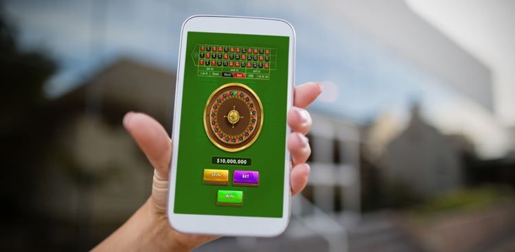Online,Roulette,Game,Against,Woman,Holding,Mobile,Phone