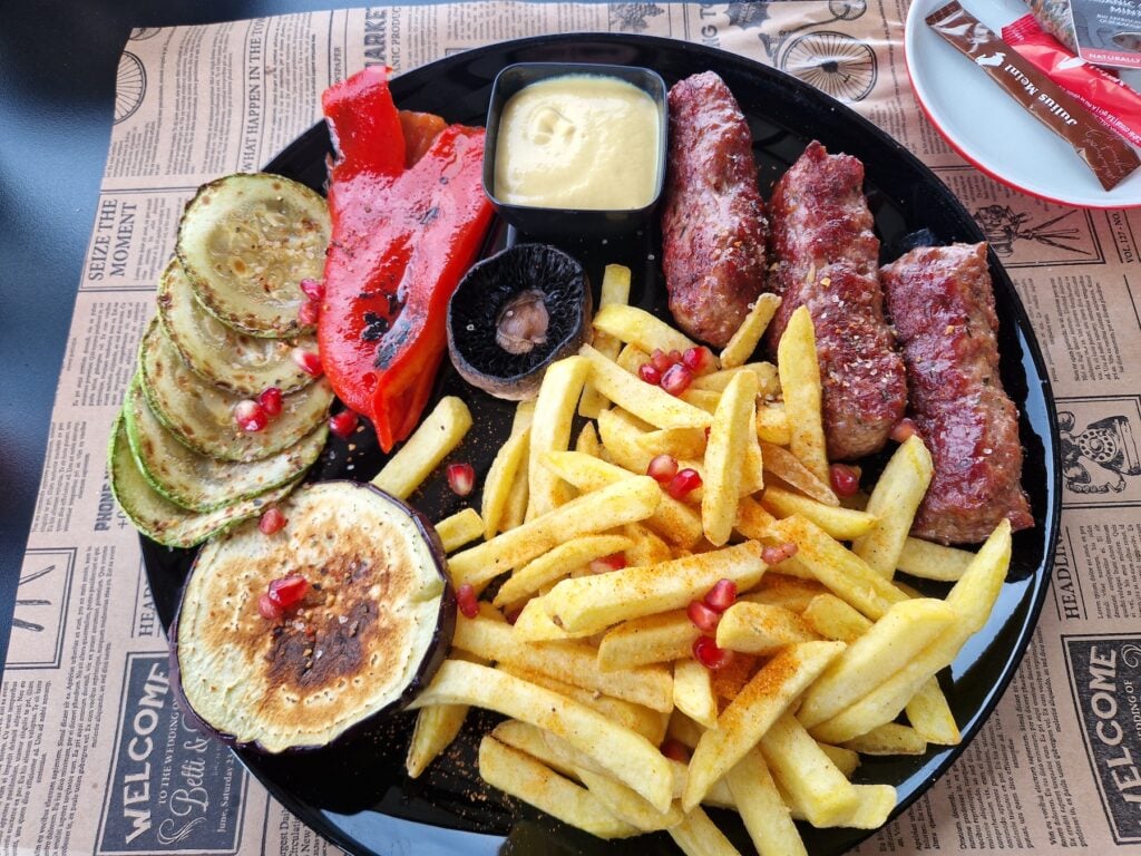 Mici cu cartofi prăjiți și legume la grătar, pe terasa Traxilvania. Foto: turnulsfatului.ro