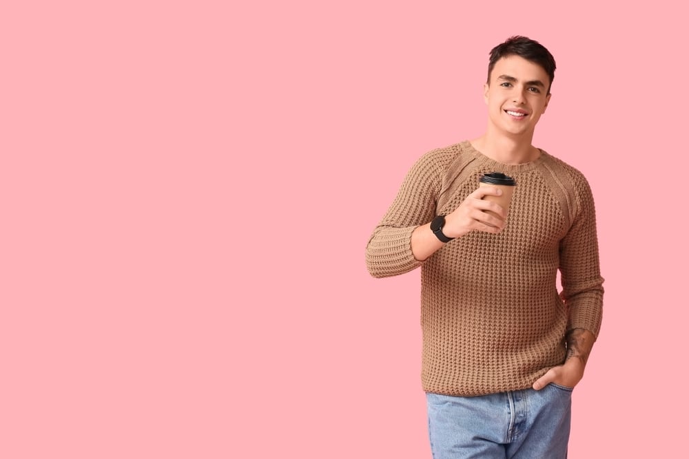 Handsome,Young,Man,In,Stylish,Brown,Sweater,With,Paper,Cup